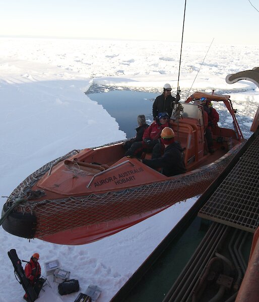 The Aurora Australis’ fast rescue craft lifts passengers from the stricken Russian vessel Akademik Shokalskiy, which became trapped in thick sea ice in 2013, from a sea ice floe on to the Australian ship.