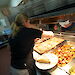 A chef at Casey filling the hot food servery.