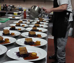 Casey Chef Eddie Dawson plating up pork belly, saffron pommes fondant and red cabbage for a mid-winter lunch.