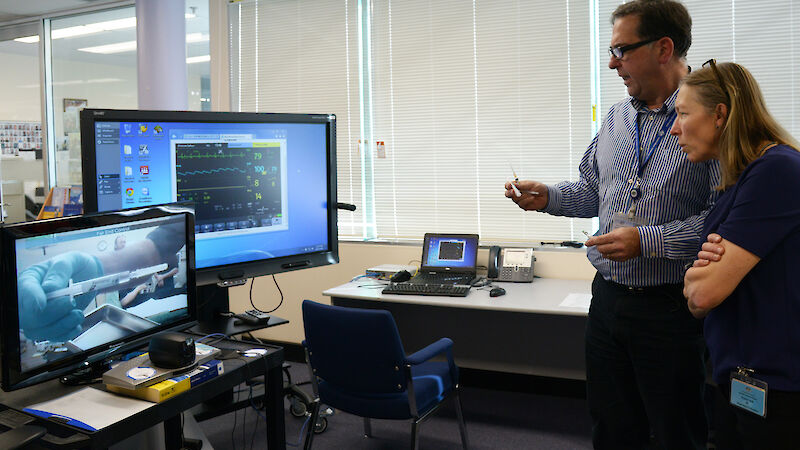 Dr Jeff Ayton and Dr Trudi Disney (Royal Hobart Hospital Specialist Anaesthetist) use telemedicine to demonstrate and remotely supervise a procedure conducted by a trained lay surgical assistant, being undertaken in real time at an Antarctic station some 4000km away. The patient’s vital signs are being monitored in real time via another screen on the right.