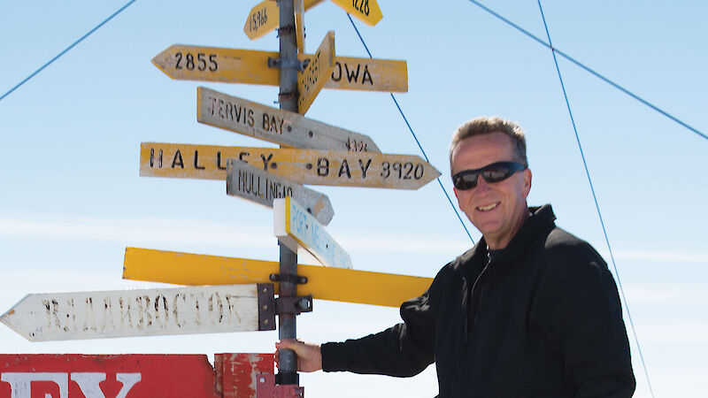 Dr Nick Gales in front of a sign at Casey research station.