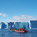 Two small boats with the Sørsdal Glacier in the background and a drone flying above the glacier.