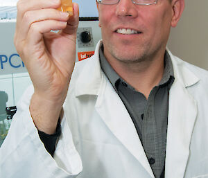 Dr Bruce Deagle holding a test tube.