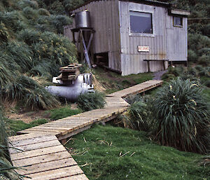 Caroline Cove hut beneath a rock peak on Macquarie Island.