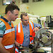 Two instrument technicians at a metal lathe.