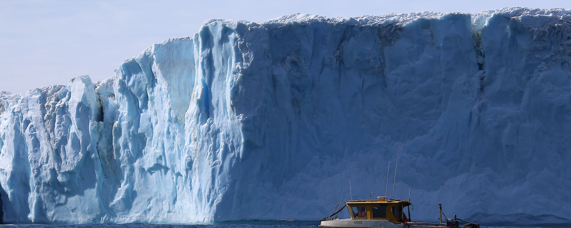 The support vessel RV Howard Burton trails the AUV as it prepares for a mission beneath the Sørsdal Glacier.