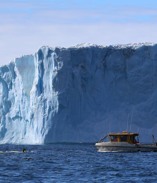 The support vessel RV Howard Burton trails the AUV as it prepares for a mission beneath the Sørsdal Glacier.
