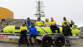 The 8 AUV team members standing beside the AUV at Davis station.
