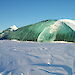 A jade iceberg rising above fast ice.