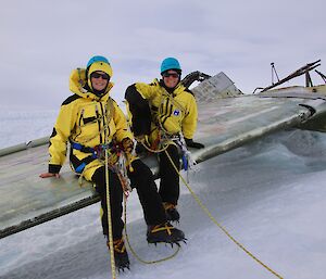 Jesse and Jane sitting on the wing of the wreckage of a Russian plane in Antarctica.