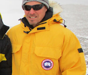 Justin Chambers wearing a yellow Antarctic jacket.