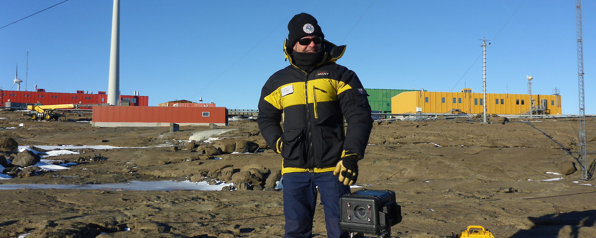 Arts Fellow Martin Walch standing with photographic equipment outside Mawson Station