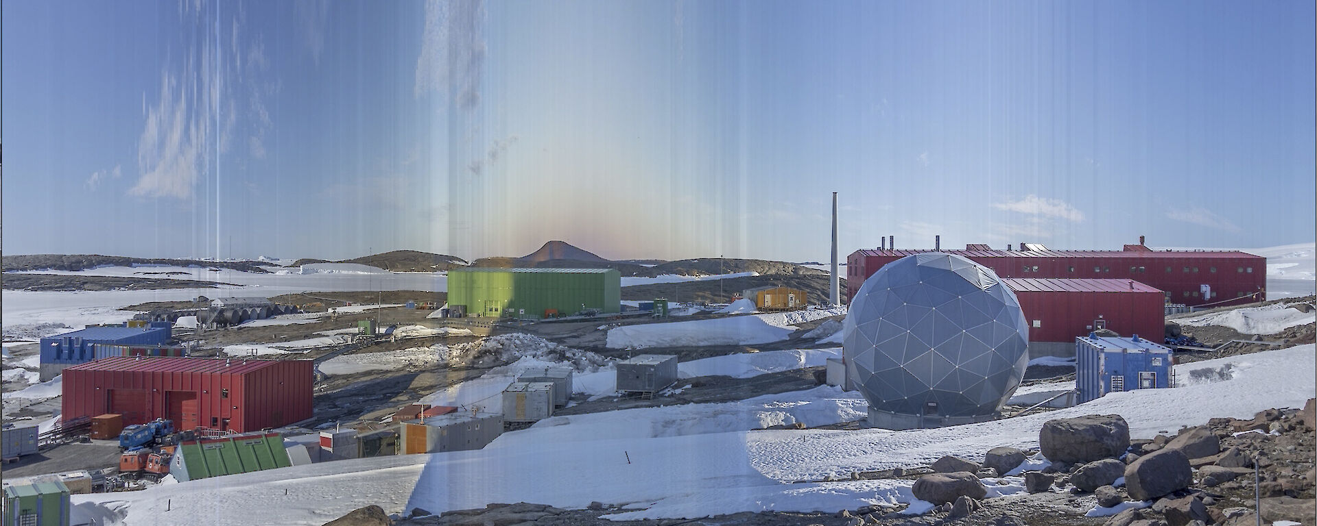 A collection of buildings in an icy landscape.