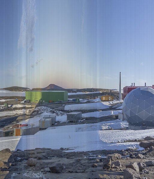 A collection of buildings in an icy landscape.