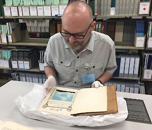 Sean Williams examining a book.