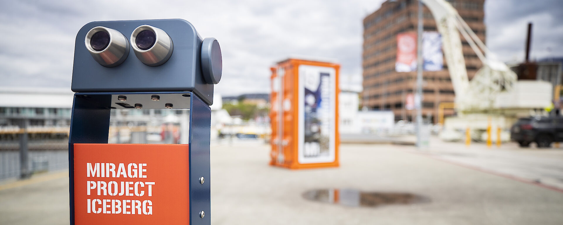 Binoculars installed at the Hobart waterfront. The sign says "This is a meeting between physical and psychological landscapes".