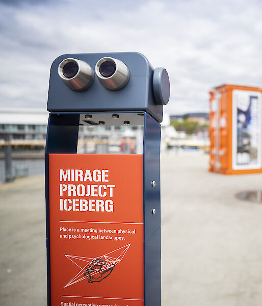Binoculars installed at the Hobart waterfront. The sign says "This is a meeting between physical and psychological landscapes".
