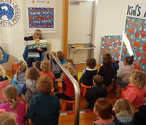 Author reading a book to young children.