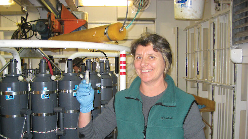 Media producer holding sample in the ship's laboratory