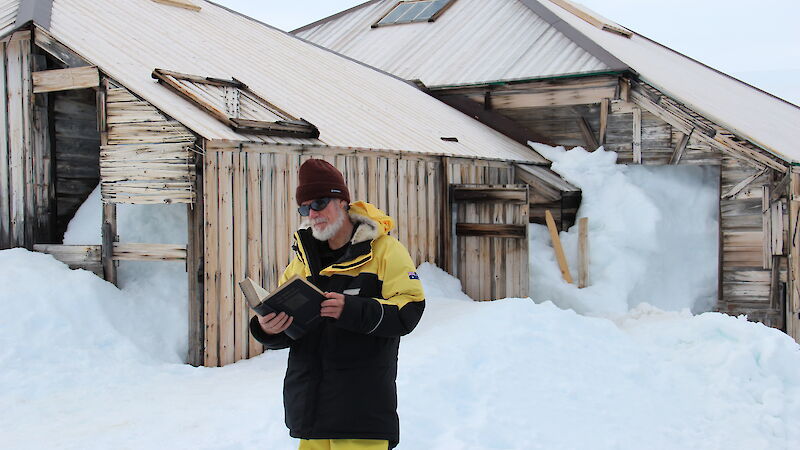 Tom Griffiths stands outside a hut in Antarctica