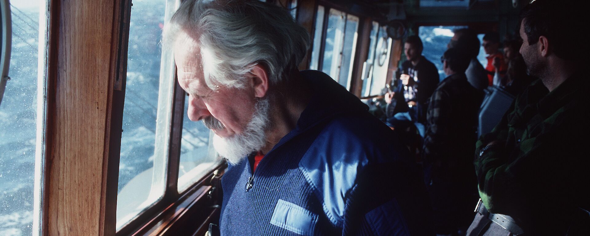 Stephen Walker sketching at a window on board a ship