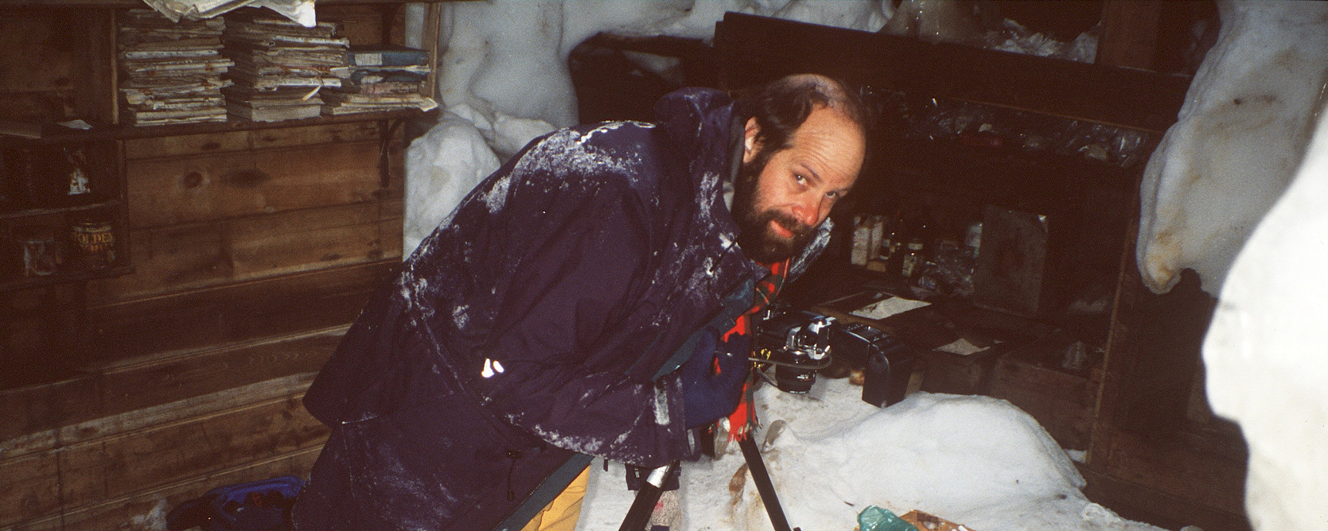 Alasdair McGregor photographing artefacts inside Mawson’s main hut