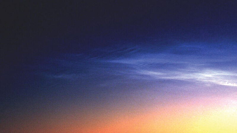 Noctilucent clouds in the Southern Hemisphere are dimmer, less frequent and higher than those in the Northern Hemisphere