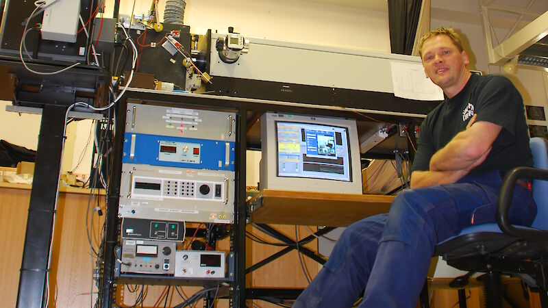 A man sits at a computer terminal in the optical laboratory at Davis station, Antarctica