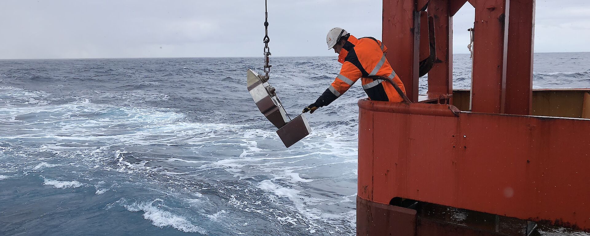 Crew member retrieving the scientific instrument on the ship.