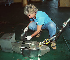 A scientist prepares the recorder to be dropped overboard.