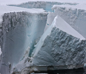 A chunk of ice breaks away from an ice cliff.