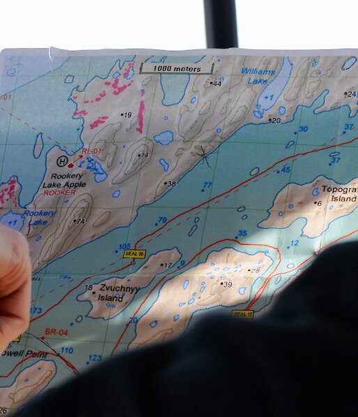 Expeditioner's hand pointing to map