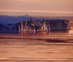 Glacial ice cliffs at sunset
