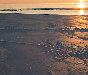 Sun rising over ice.