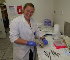 A female scientist in the lab with a shellfish for analysis