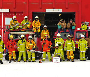 Fire team in full safety gear pose as group