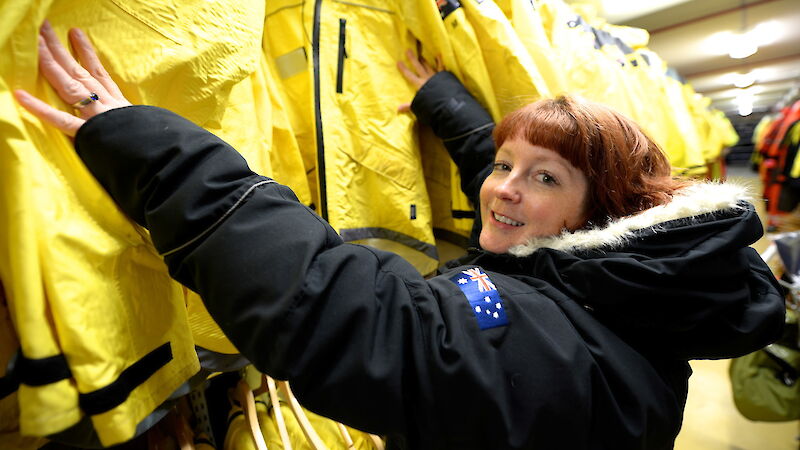 Expeditioner with racks of yellow clothes.