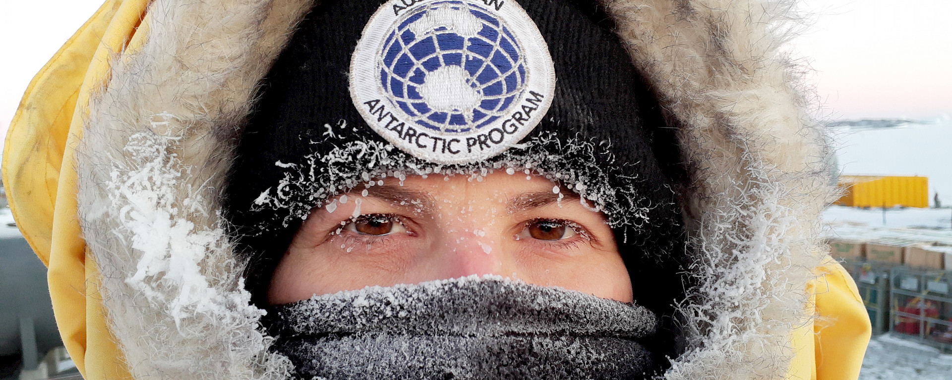 Close up of a woman in cold weather gear with ice on her eyelashes.