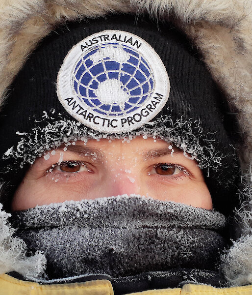 Close up of a woman in cold weather gear with ice on her eyelashes.