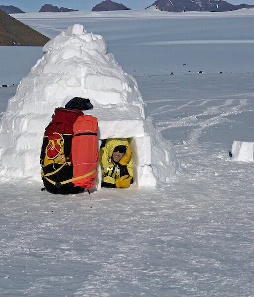 Expeditioner in entry of completed igloo
