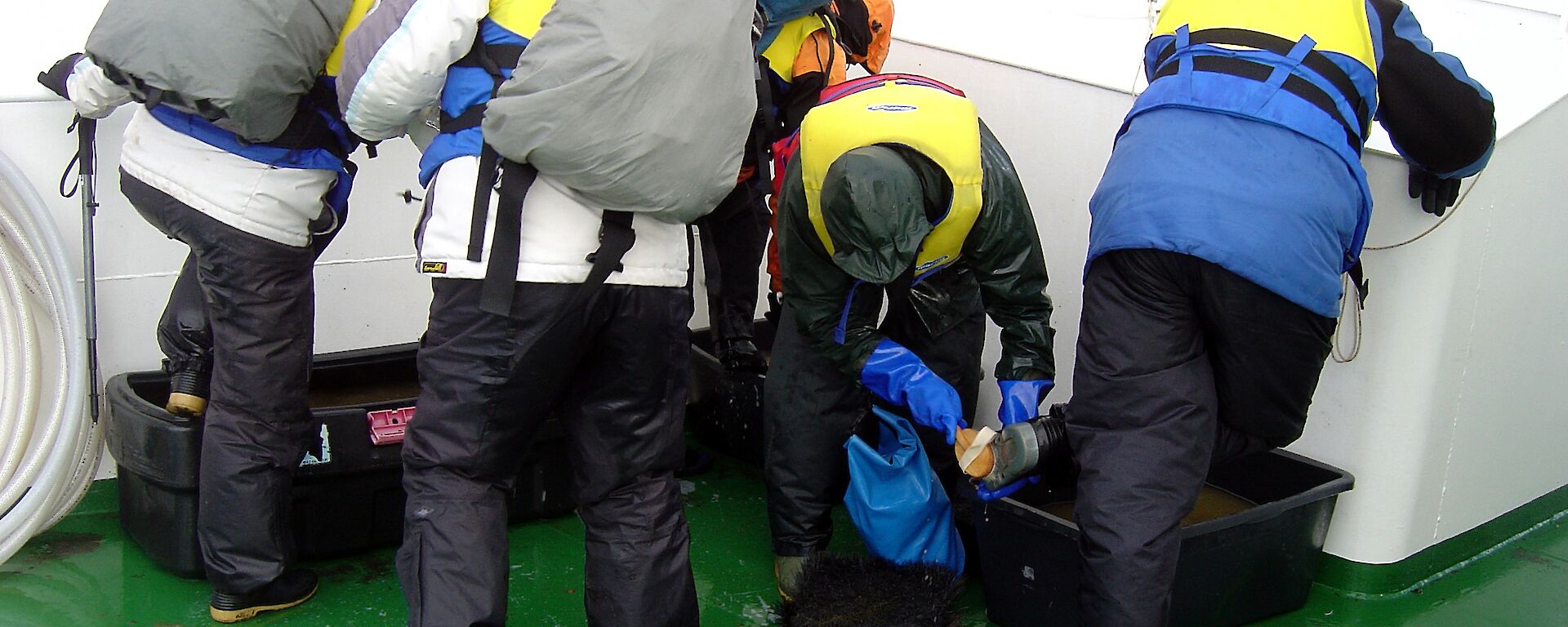 Tourists scrub the soles of their boots.