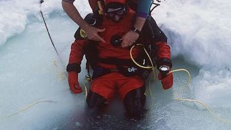 Diver being assisted with harness