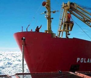 Crew member signalling with their hand, from the bow of the Polar Bird