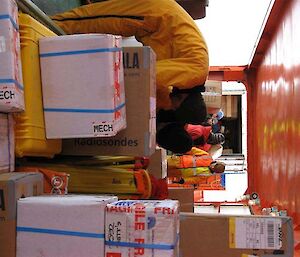 Expeditioners with boxes on deck of ship