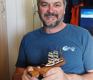 Man holding miniature ship