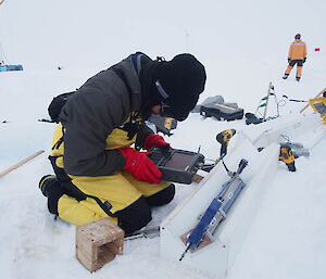 David takes microwave measurements of a thin section of ice core in his ‘wave guide’. (Photo Wendy Pyper)