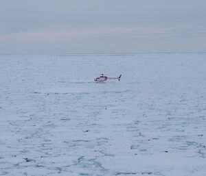 The helicopter deploying an accelerometer on the ice (Photo: Wendy Pyper)