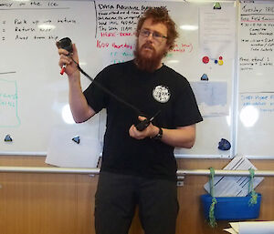 Field Training Officer Christian Gallagher demonstrates the use of VHF radio (Photo: Wendy Pyper)