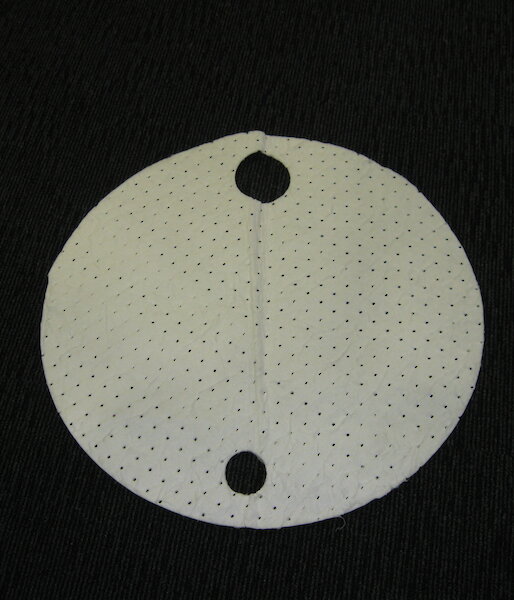 One of the pieces of fuel absorbent polypropylene designed to fit on a 44-gallon fuel drum.