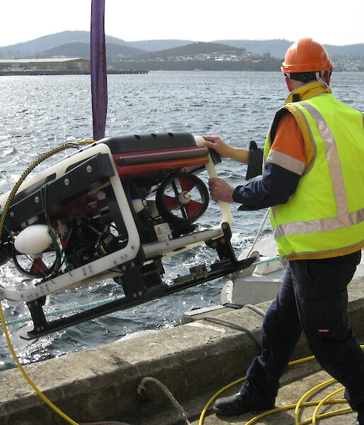 The ROV being lowered by a crane into the Derwent River.